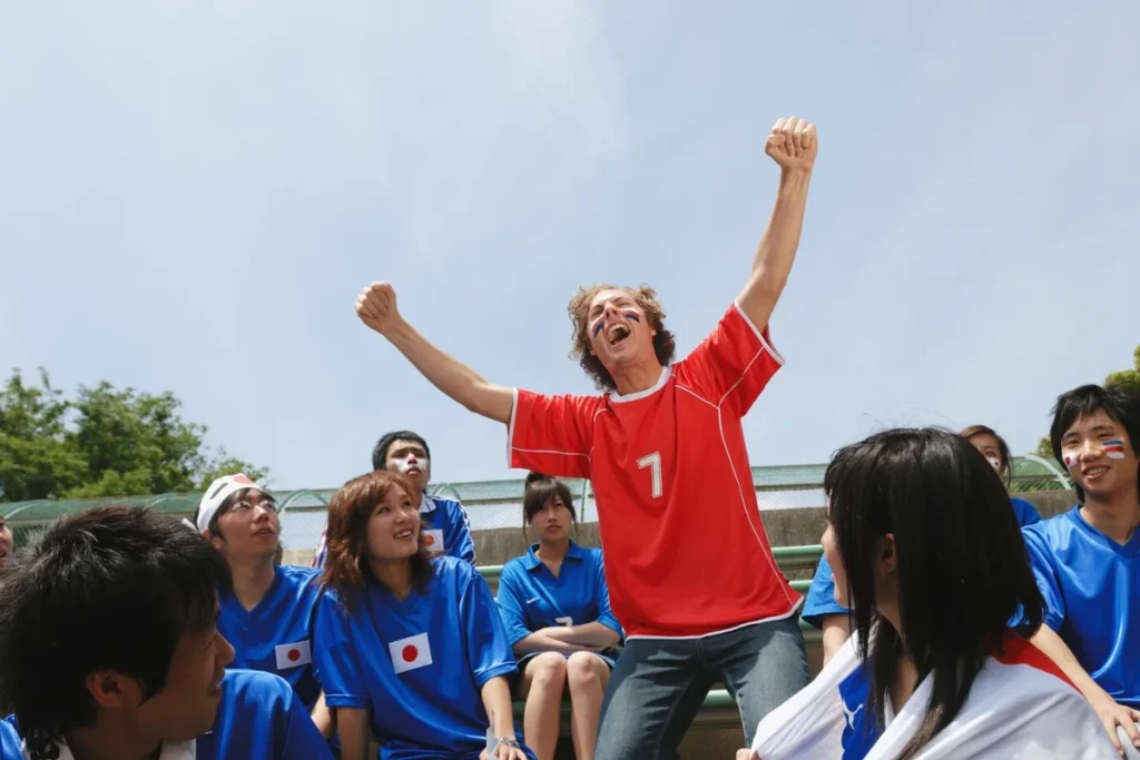 Excited Soccer Fan Celebrating in Red Jersey by Aflo Images