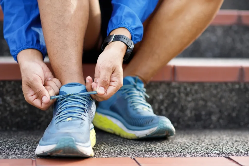 Atlet running pria mengikat sepatu beriap untuk berlari atau jogging